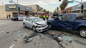 Damaged vehicles after uninsured driver crash in San Bernardino with debris on roadway